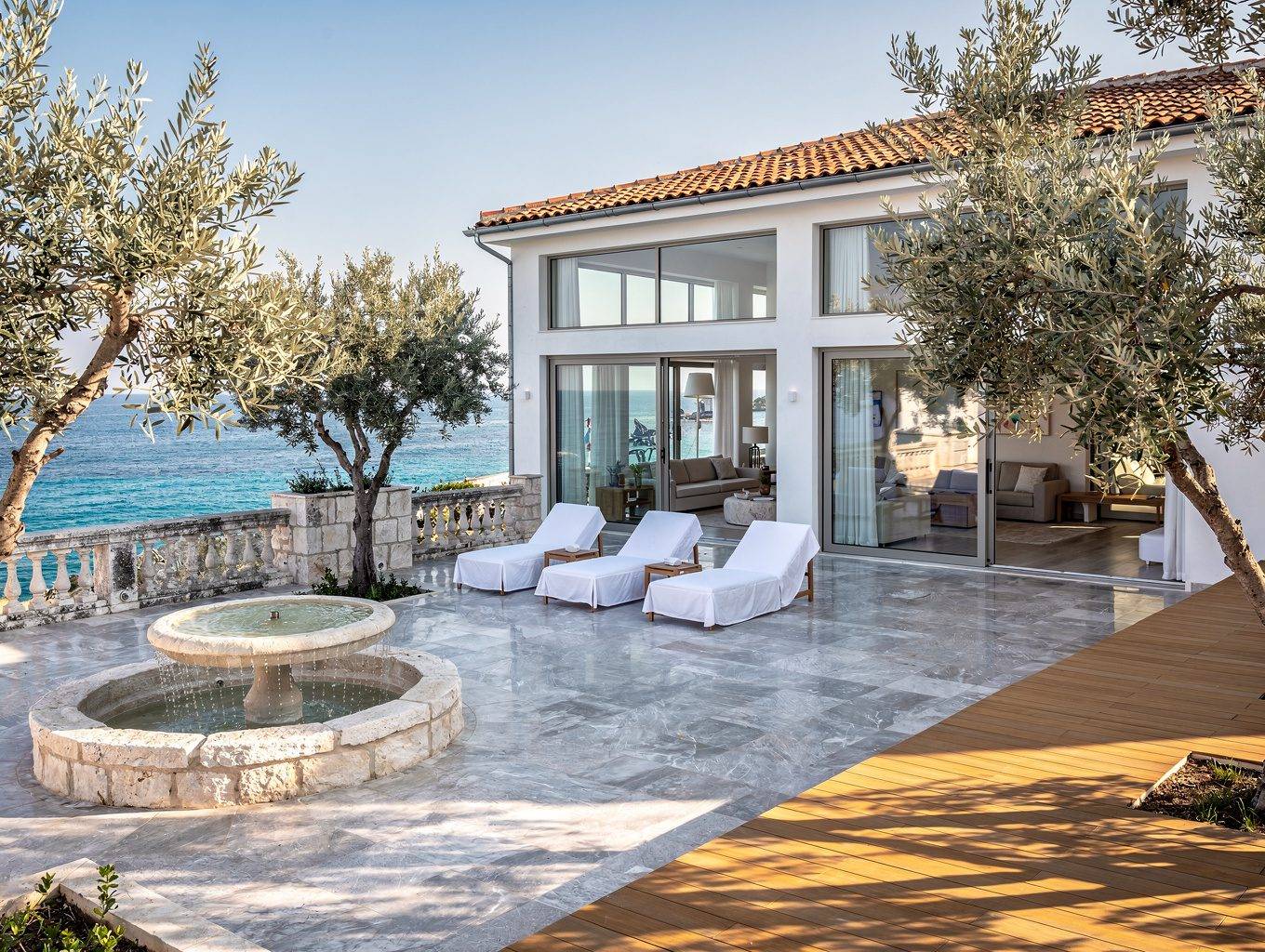 Nestivo Hospitality - Airbnb Property Management Corfu 3 Professional photographer capturing a luxury villa interior for an Airbnb listing