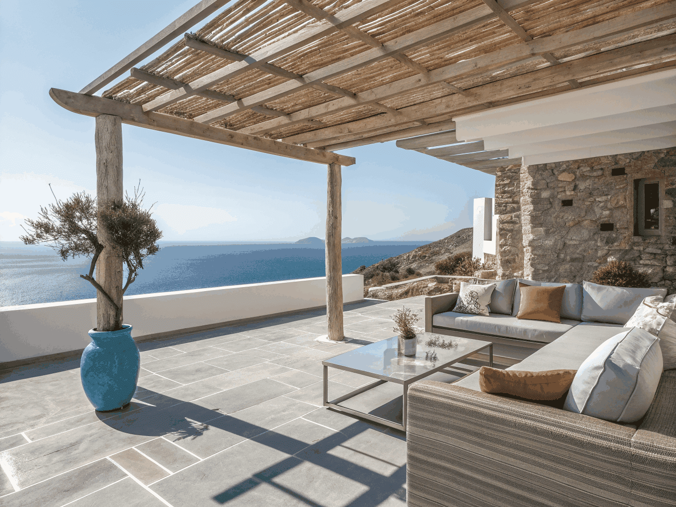 Villa owner managing Corfu property with tablet on luxury terrace overlooking Ionian sea